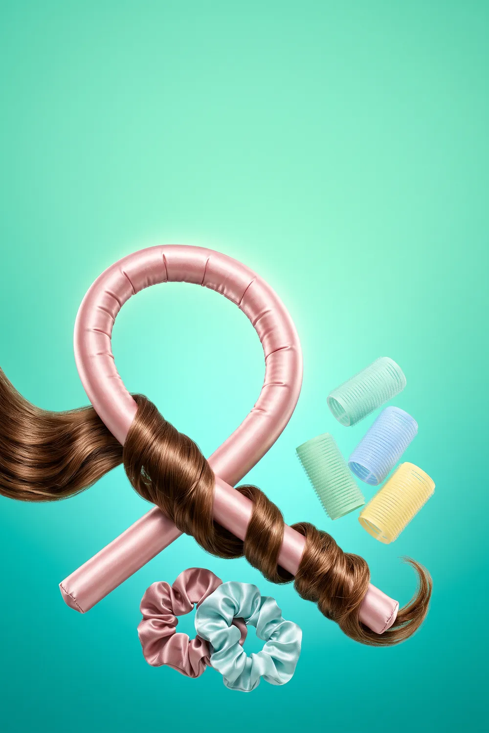 A glossy satin heatless curling rod, two satin scrunchies and colorful self-grip rollers floating against a bright violet backdrop